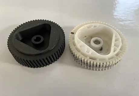 A black and white plastic gear on top of a table.